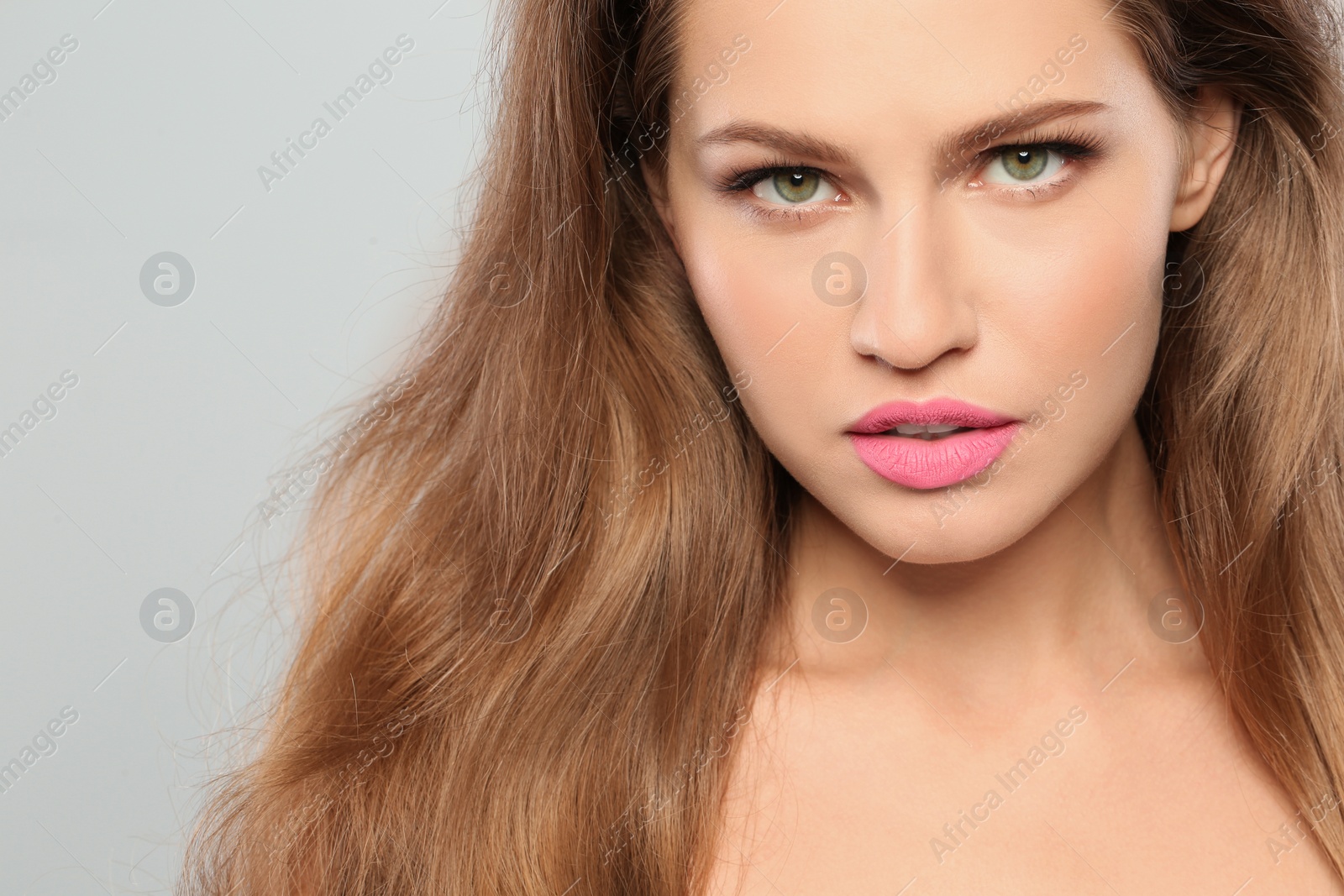 Photo of Young woman wearing beautiful lipstick on gray background