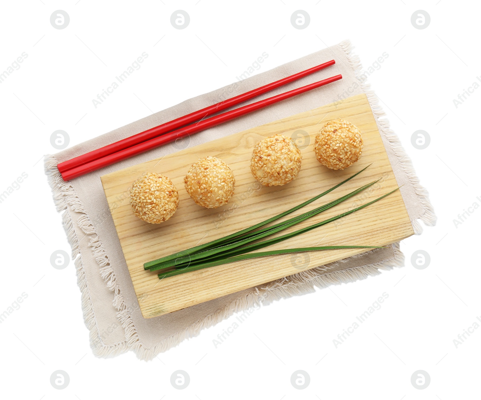 Photo of Delicious sesame balls, green leaves and chopsticks on white background, top view