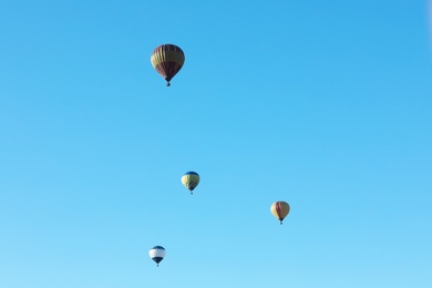 Photo of Colorful hot air balloons flying in blue sky