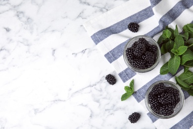 Flat lay composition with tasty blackberries and space for text on marble table