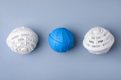 Photo of Dryer balls for washing machine on light grey background, flat lay