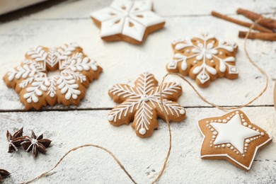 Delicious homemade Christmas cookies and flour on wooden table, closeup