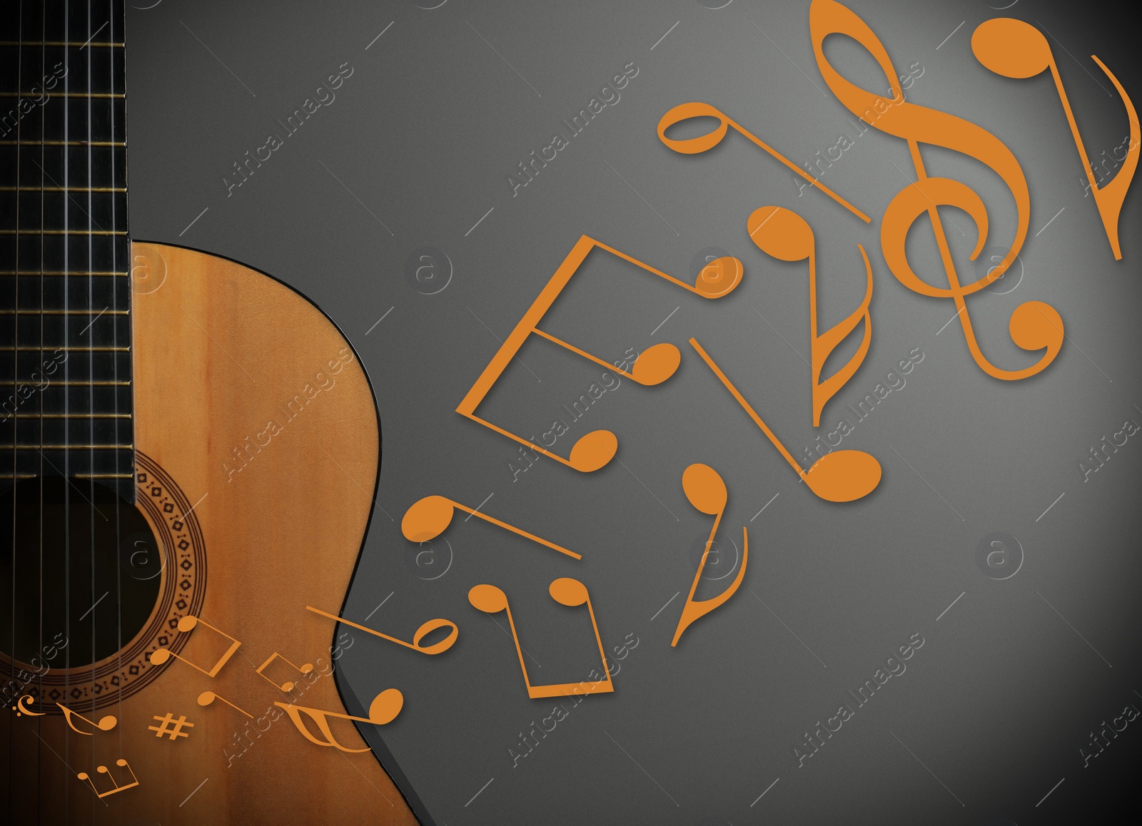 Image of Music notes and other musical symbols flowing from acoustic guitar on grey background, closeup