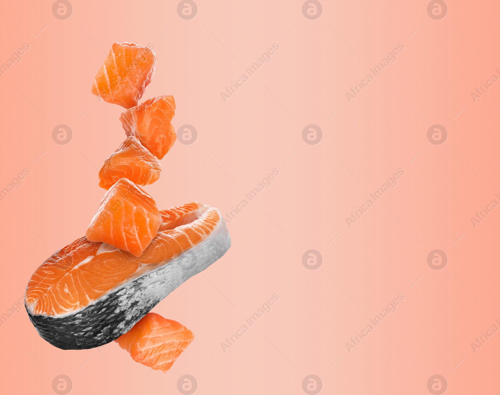 Image of Cut fresh salmon falling on pastel coral background, space for text