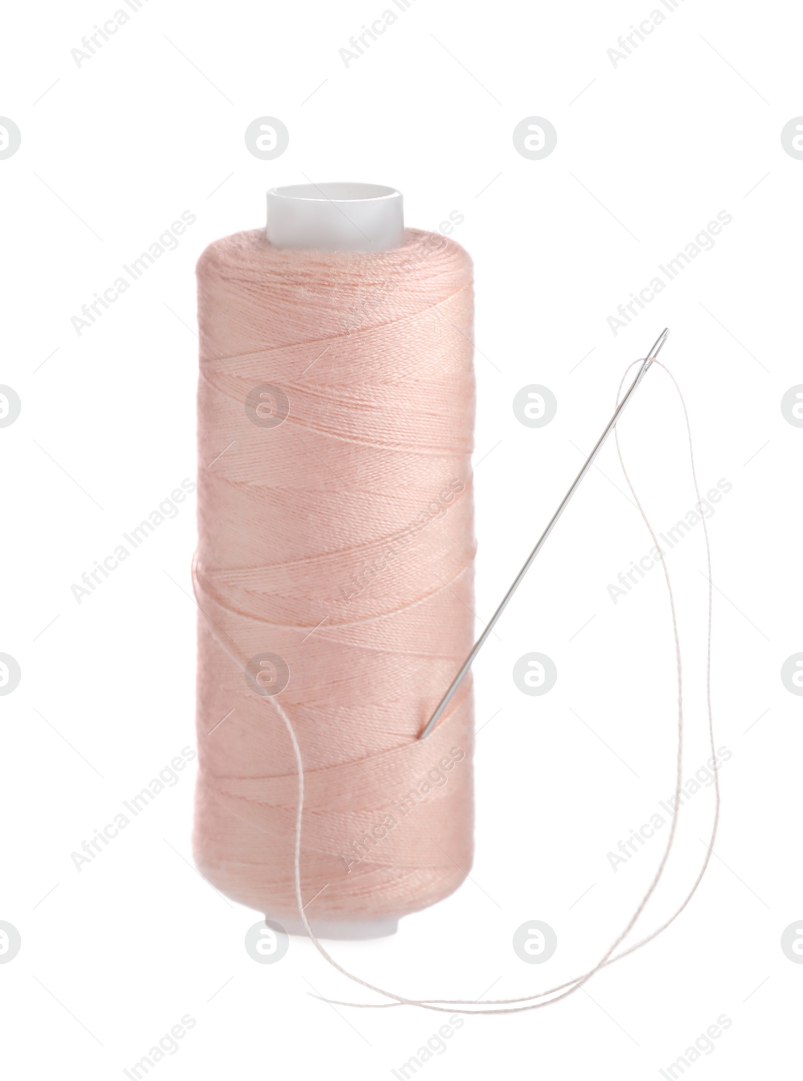 Photo of Pink sewing thread with needle isolated on white