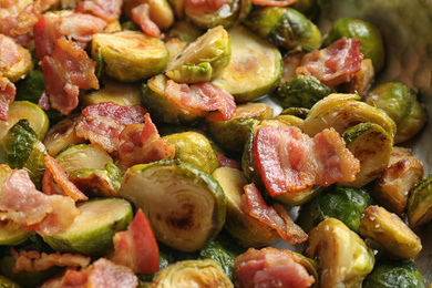 Photo of Delicious roasted Brussels sprouts with bacon as background, closeup