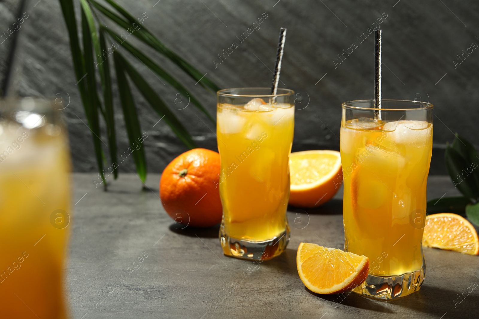 Photo of Delicious orange soda water on grey table