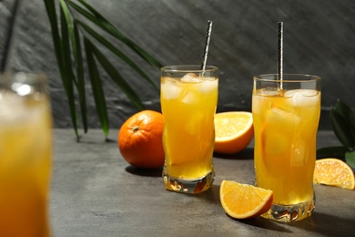 Photo of Delicious orange soda water on grey table