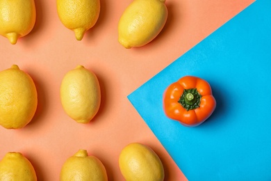 Photo of Bell pepper in front of lemons on color background, top view. Be different