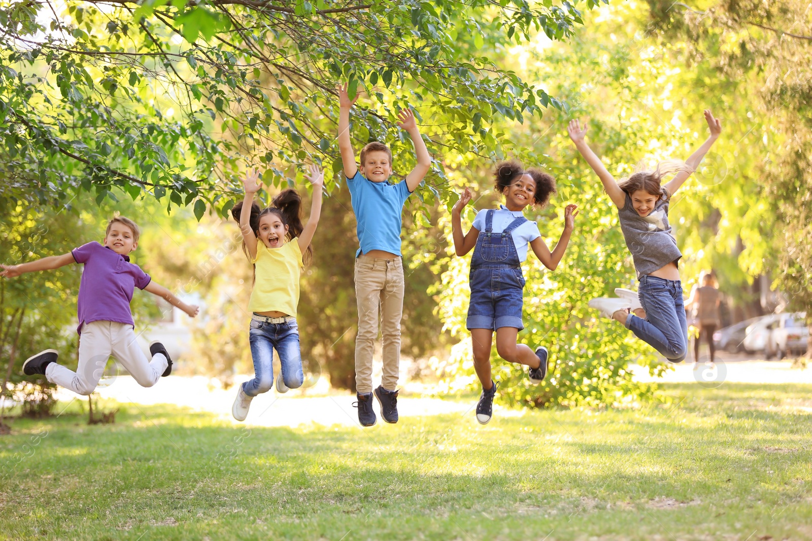 Photo of Cute little children playing together outdoors on sunny day