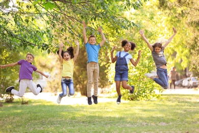 Photo of Cute little children playing together outdoors on sunny day