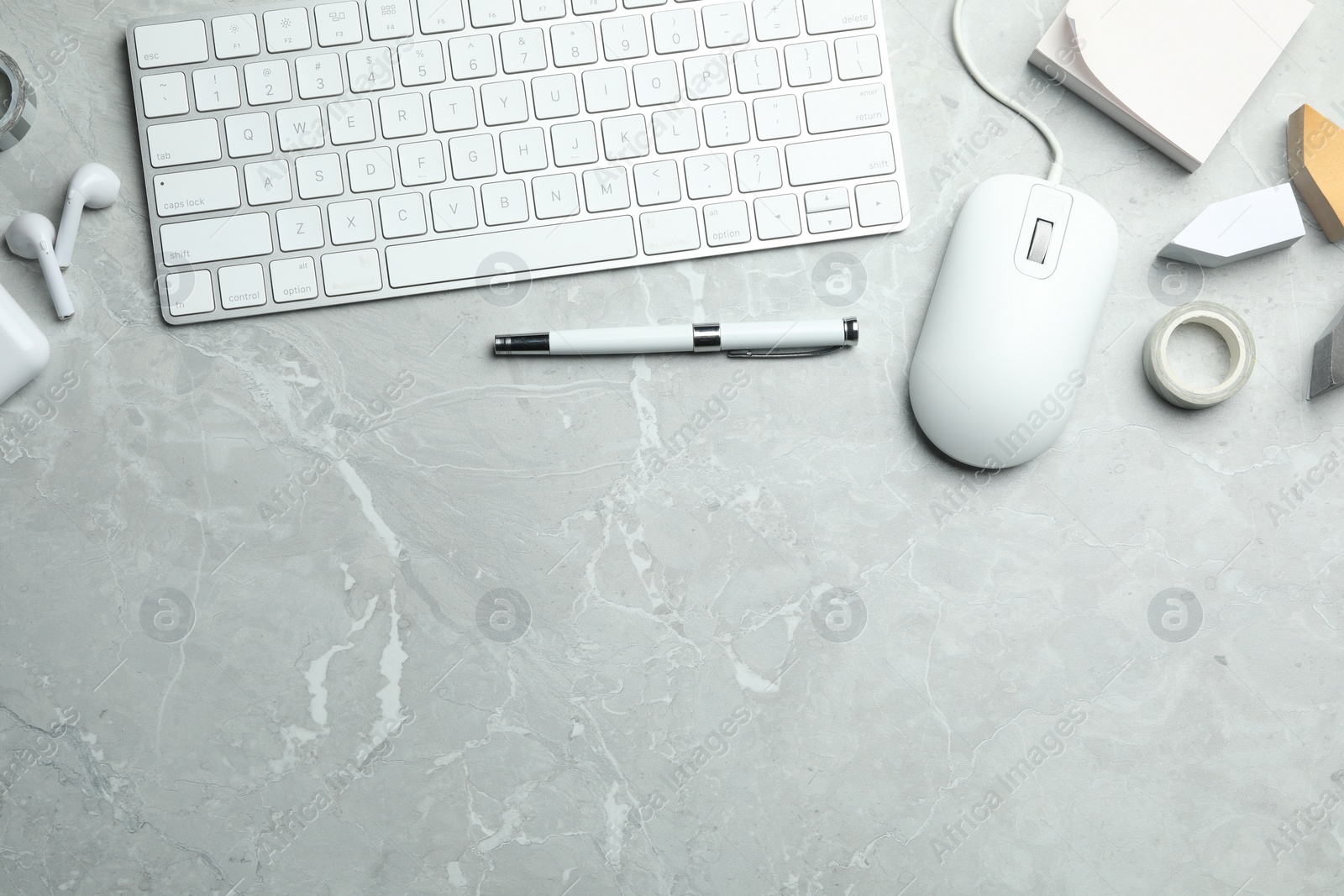 Photo of Flat lay composition with wired computer mouse and keyboard on light grey marble table. Space for text