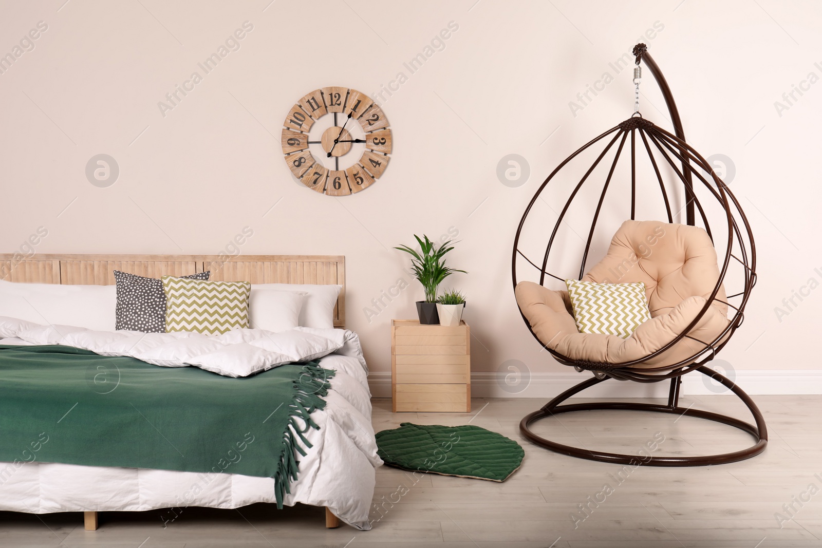 Photo of Modern bedroom interior with comfortable hanging chair. Stylish design