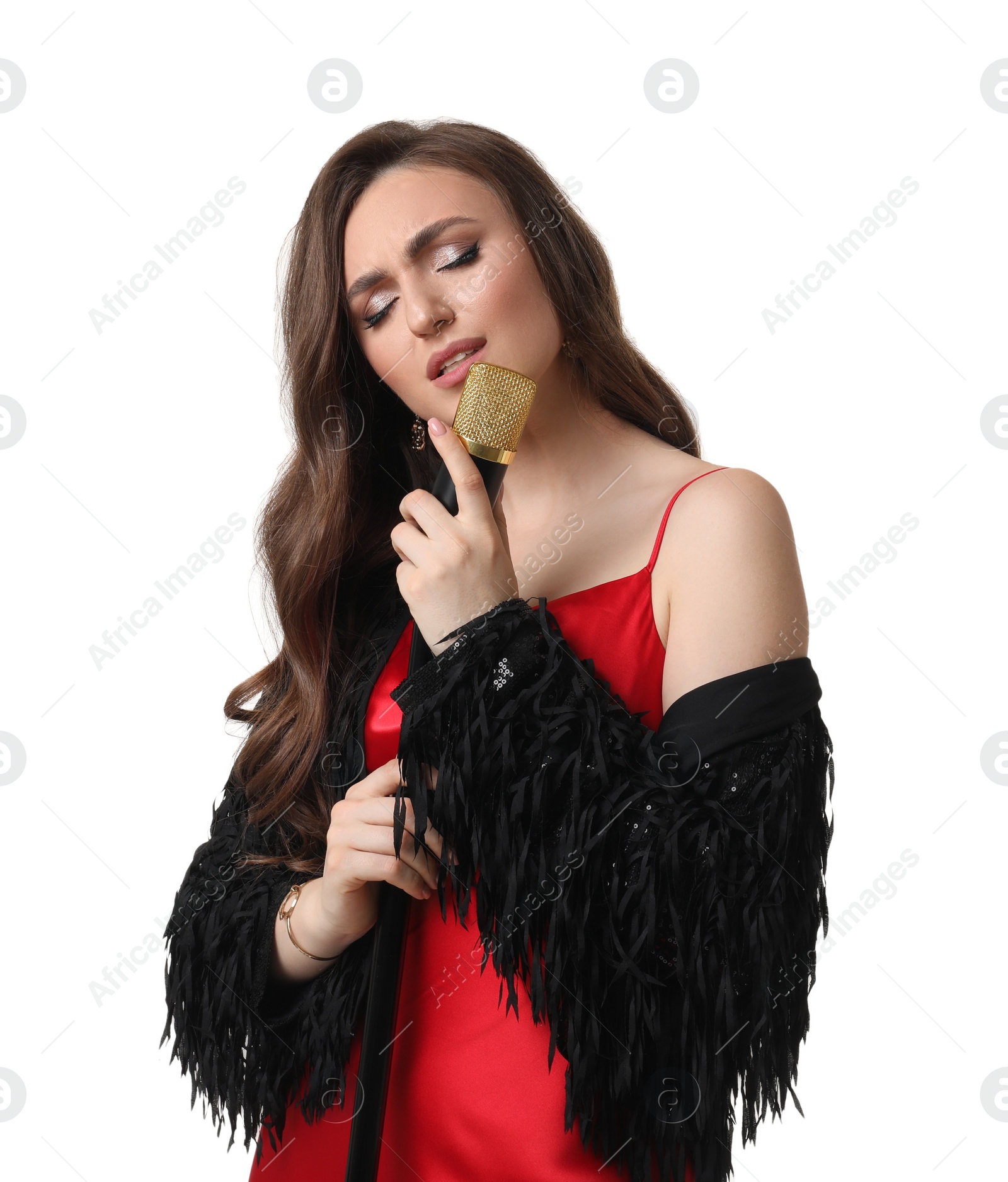 Photo of Beautiful young woman in stylish red dress with microphone singing on white background