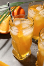 Delicious orange soda water on grey table