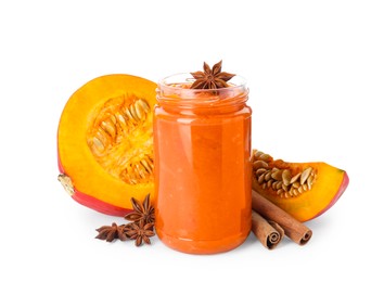 Photo of Jar of pumpkin jam, star anise, fresh pumpkin and cinnamon on white background