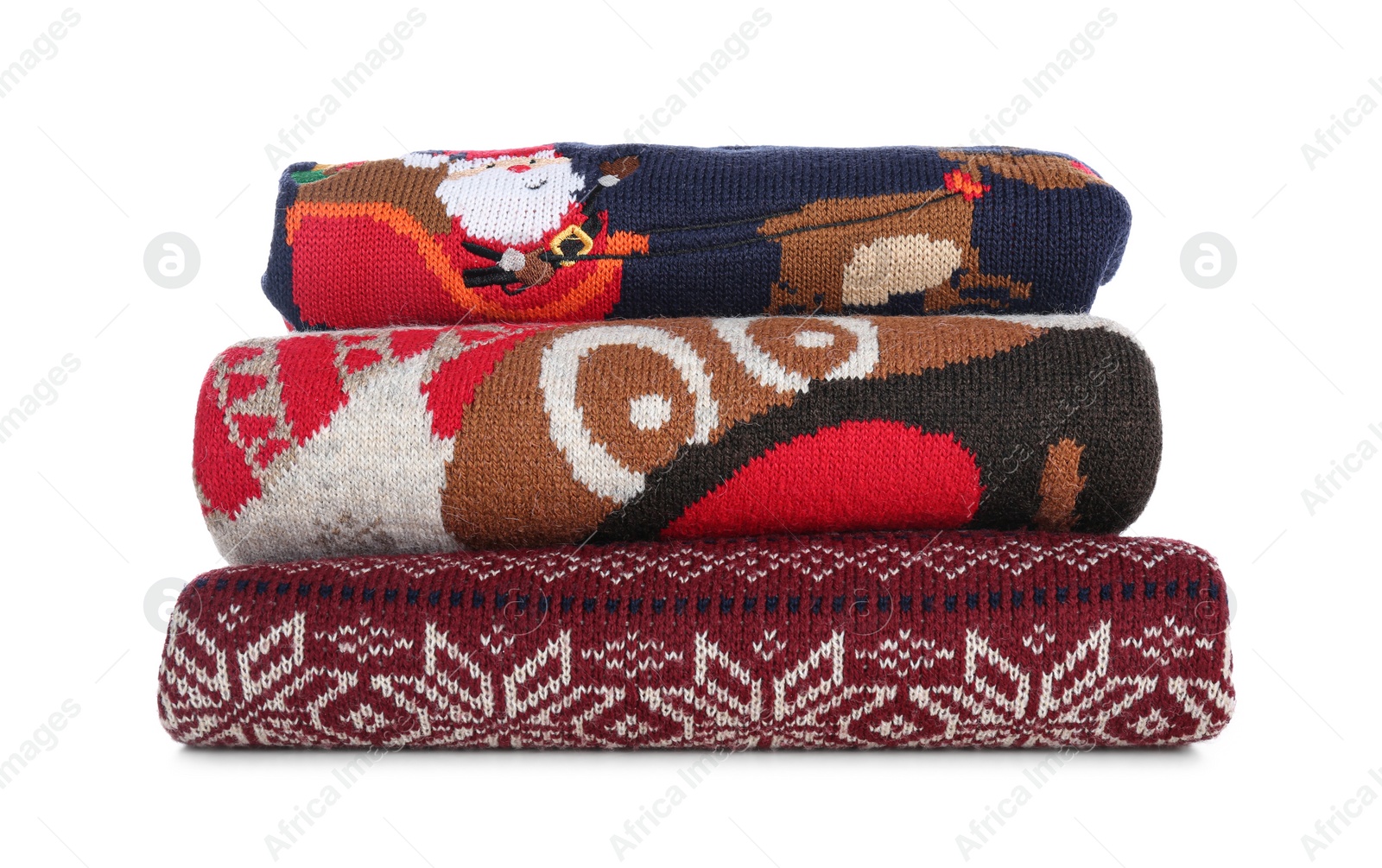 Photo of Stack of warm Christmas sweaters isolated on white