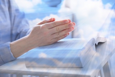 Religion. Double exposure of sky and Christian woman praying over Bible at table, closeup