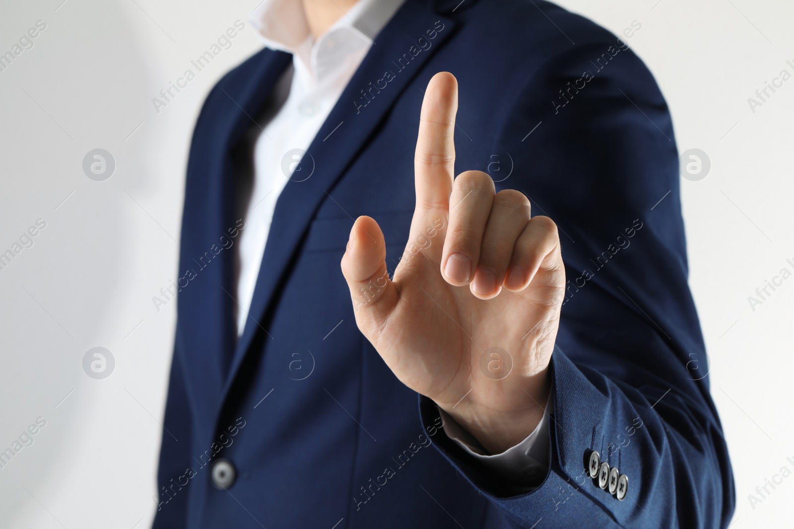 Photo of Man scanning fingerprint on light grey background, closeup