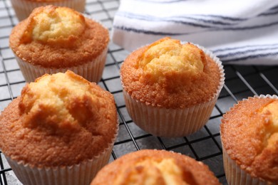 Delicious sweet muffins on grey table, closeup