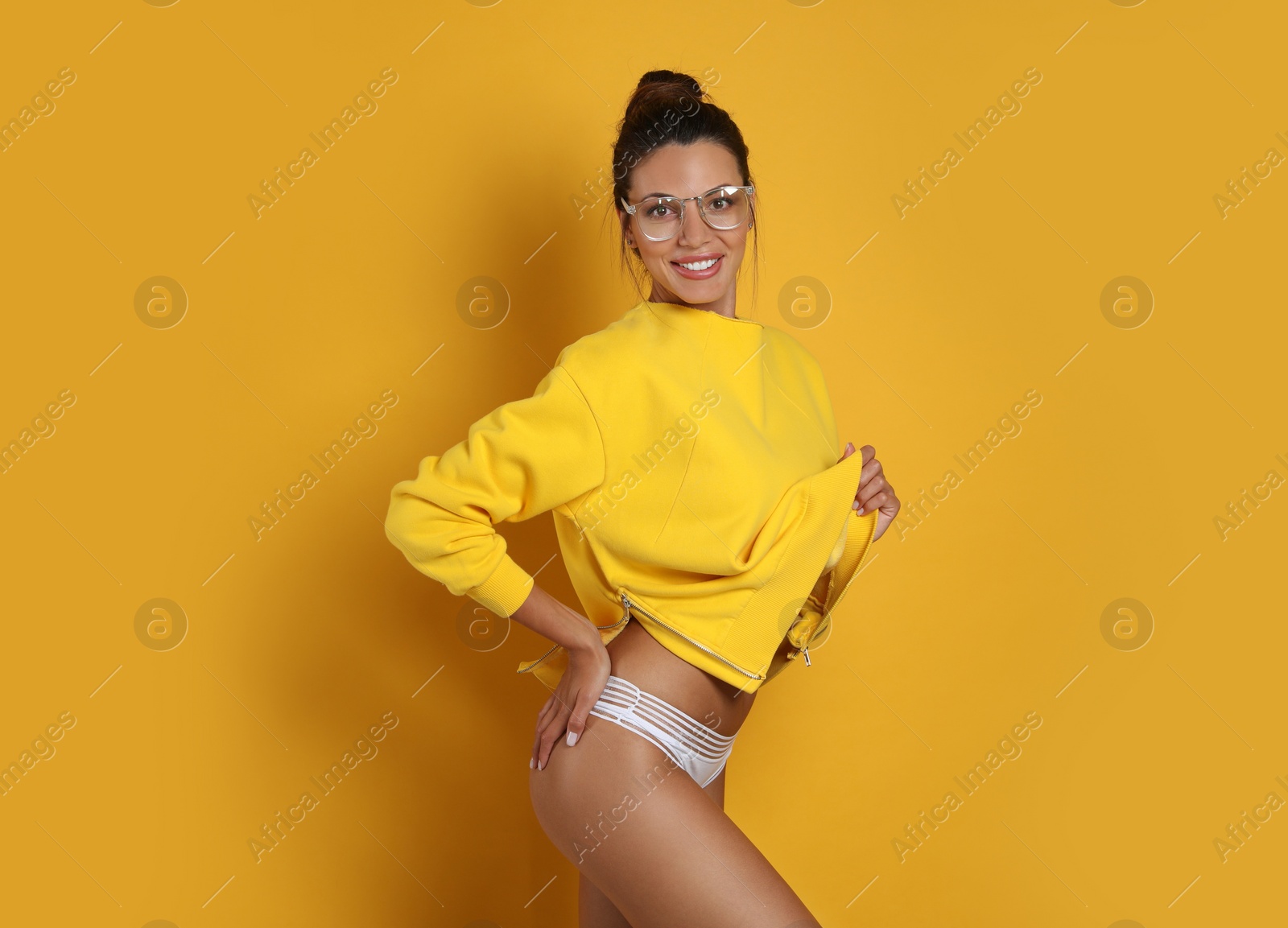 Photo of Beautiful woman in white panties on yellow background