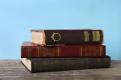 Stack of old books on wooden table