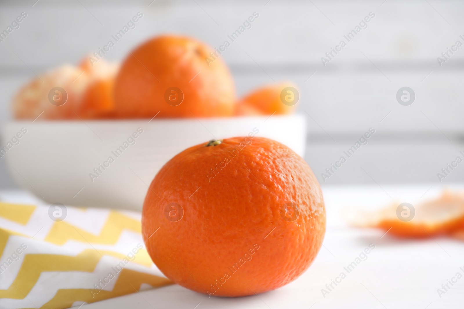 Photo of Delicious fresh ripe tangerine on white table