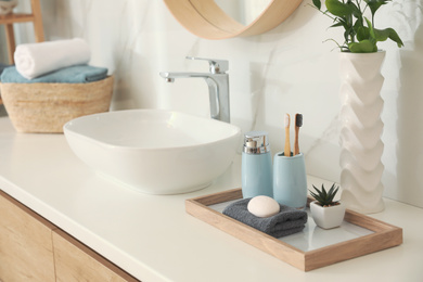 Countertop with sink and toiletries in bathroom. Interior design