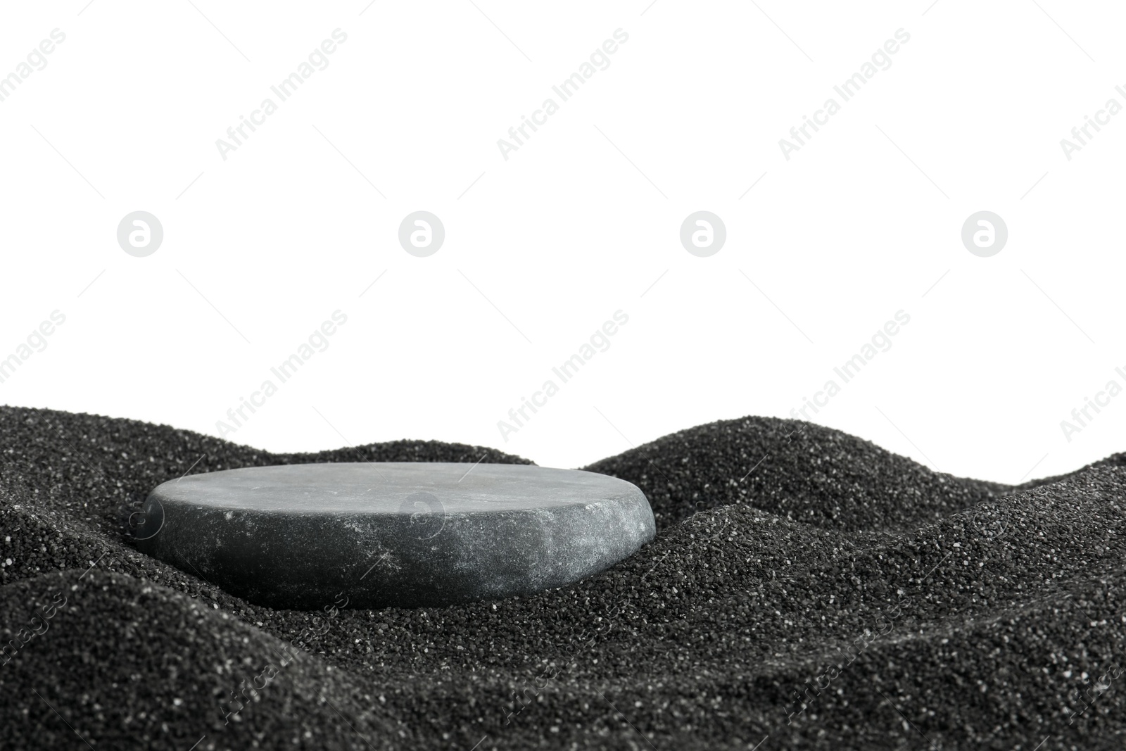 Photo of Presentation of product. Stone podium on black sand against white background