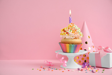 Photo of Composition with birthday cupcake on pink background. Space for text