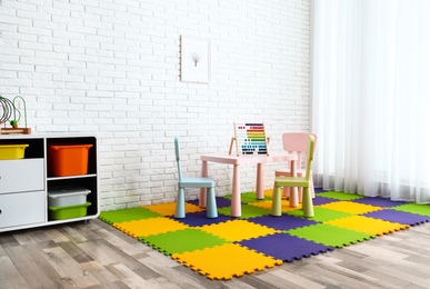 Photo of Stylish playroom interior with toys and modern furniture