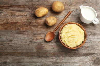 Photo of Flat lay composition with mashed potatoes on wooden background. Space for text