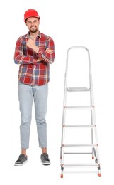 Photo of Young handsome man in hard hat near metal ladder on white background