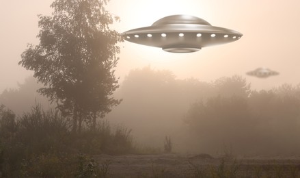 Alien spaceships flying on foggy morning. UFO