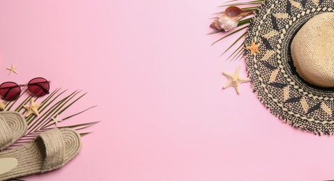 Photo of Beach accessories on pink background, flat lay. Space for text