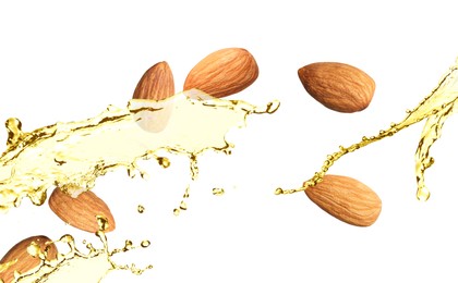 Organic almond oil and tasty nuts flying on white background