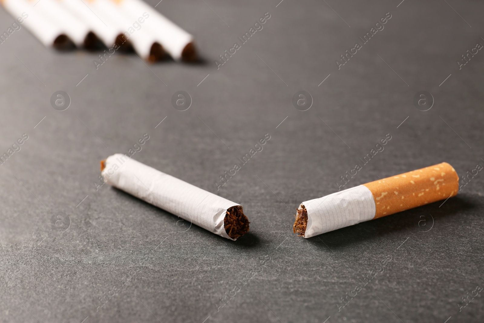 Photo of Broken cigarette on black table, closeup. No smoking concept