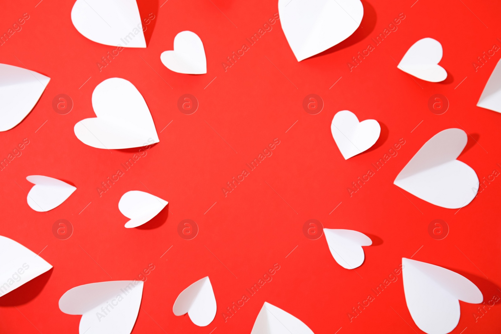 Photo of Small paper hearts on color background, top view