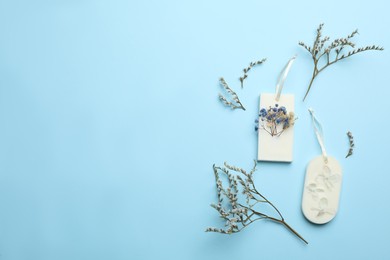 Photo of Flat lay composition with scented sachets on light blue background, space for text