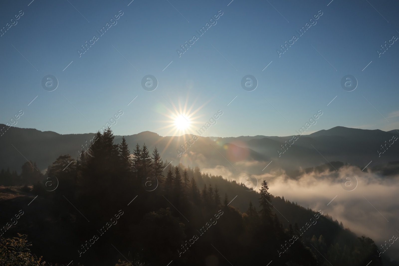 Photo of Beautiful view of mountains covered with fog at sunrise