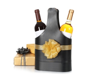 Photo of Festive package with bottles of wine and gift boxes on white background