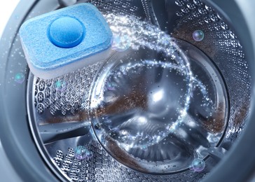 Image of Water softener tablet in washing machine drum, closeup