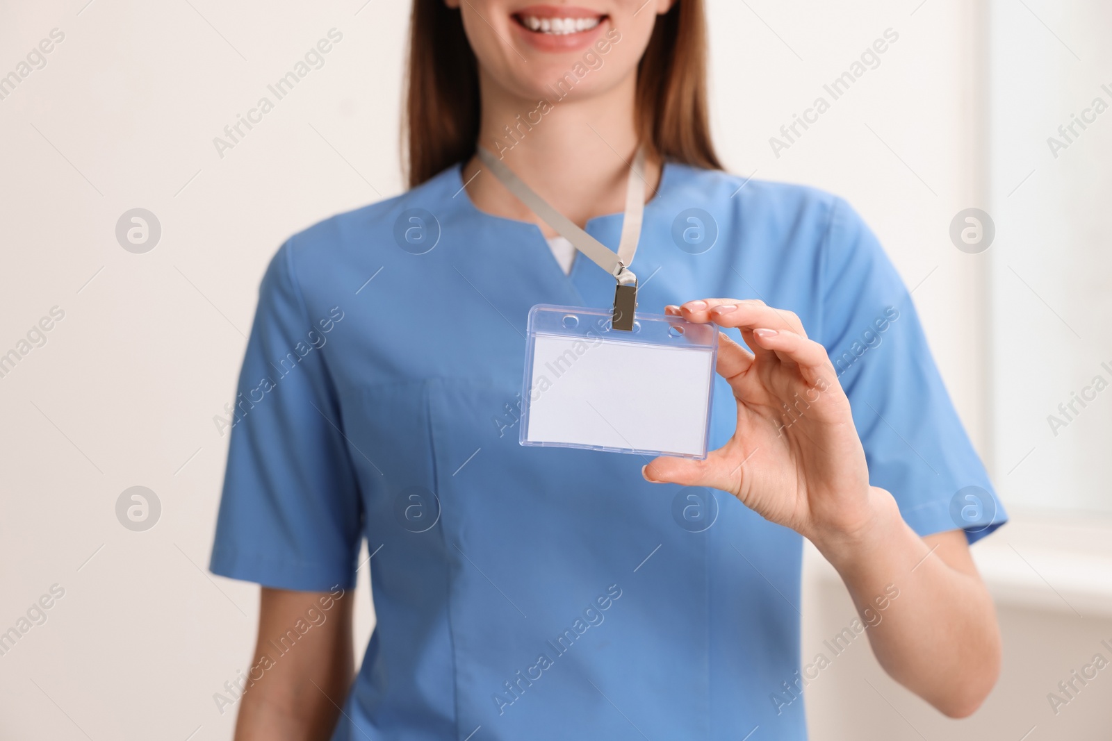 Photo of Doctor with blank badge in hospital, closeup