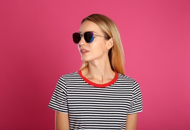 Photo of Beautiful woman in stylish sunglasses on pink background