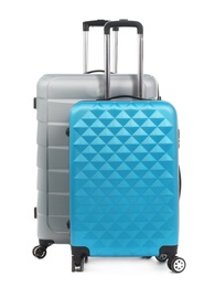 Photo of New suitcases packed for journey on white background