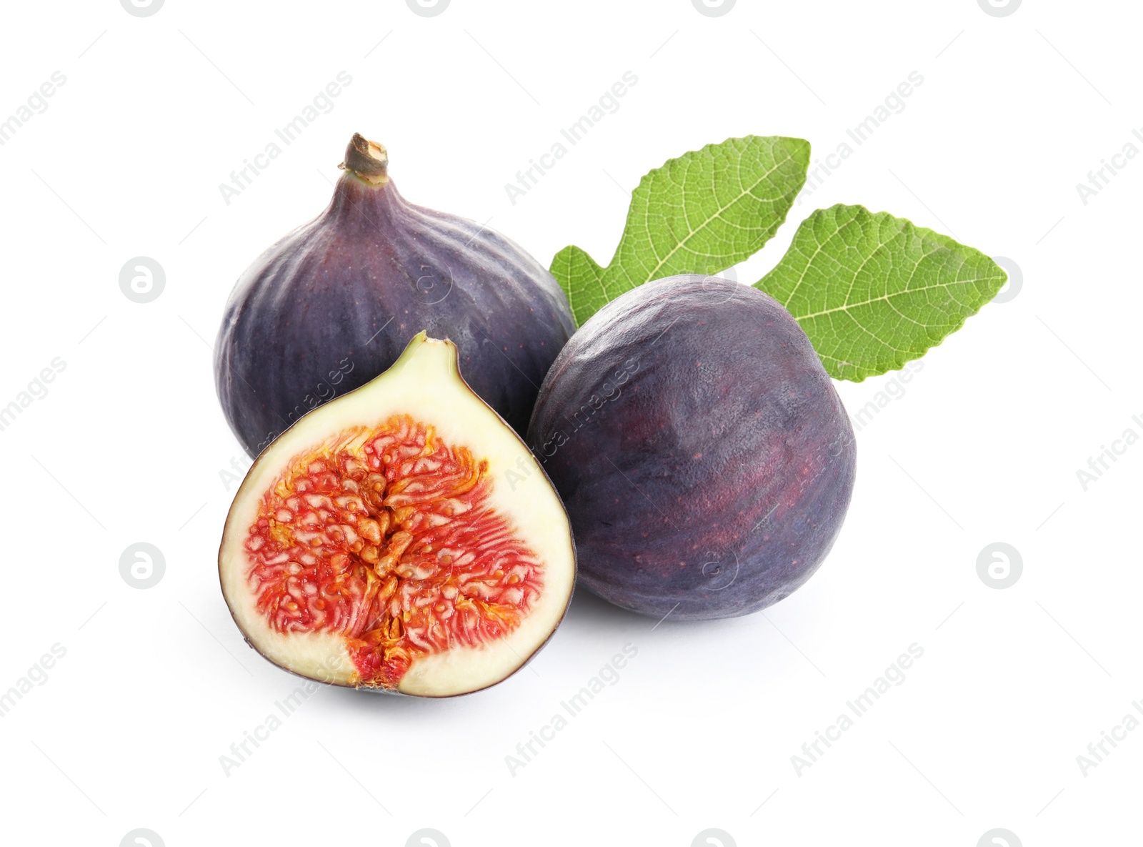 Photo of Whole and cut purple figs on white background