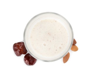 Glass of delicious date smoothie, dried fruits and nuts on white background, top view