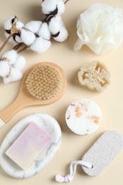 Bath accessories. Flat lay composition with personal care products and cotton flowers on beige background