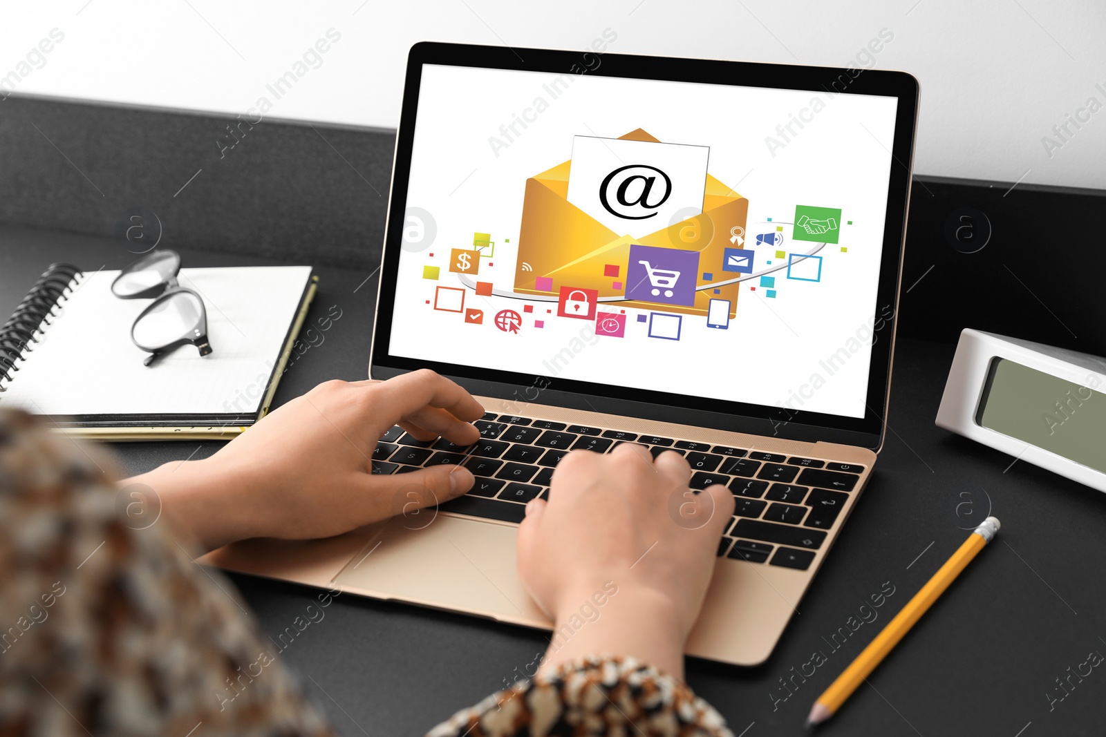 Image of Email marketing. Woman using laptop at table, closeup