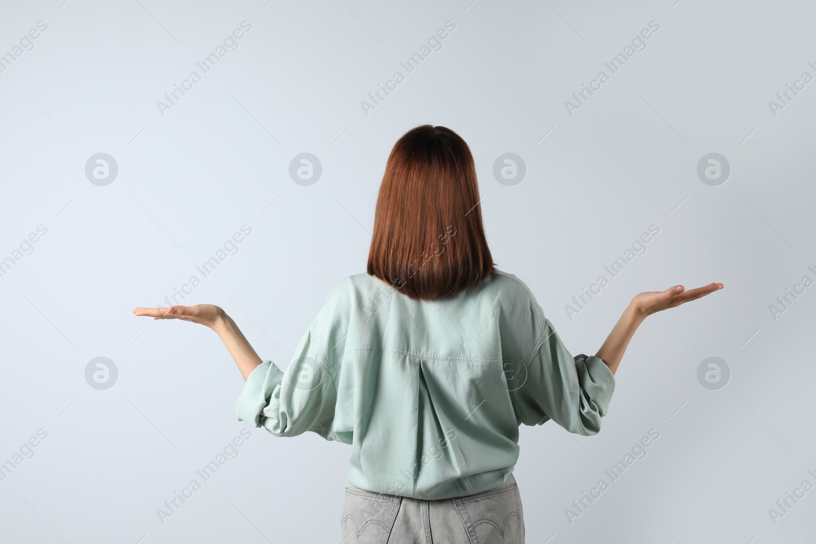 Photo of Girl wearing blouse on white background, back view